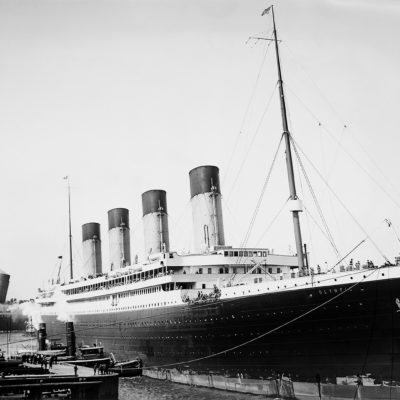The Olympic pulling up to her Manhattan pier at the end of her maiden voyage. Behind her, the Lusitania is pulling out of Pier 54 to begin an eastward crossing, (Library of Congress, J. Kent Layton Collection)